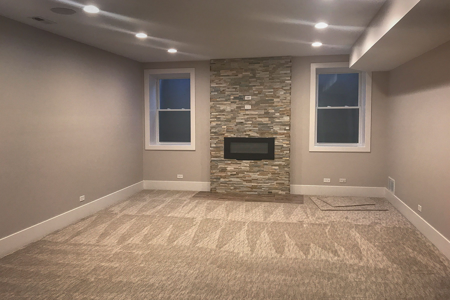 Basement Family Room with Fireplace - Custom Home, Echo Lane, Glenview, IL Custom Home. America's Custom Home Builders: New Construction, Remodeling, Restoration Services. Residential and Commercial.
