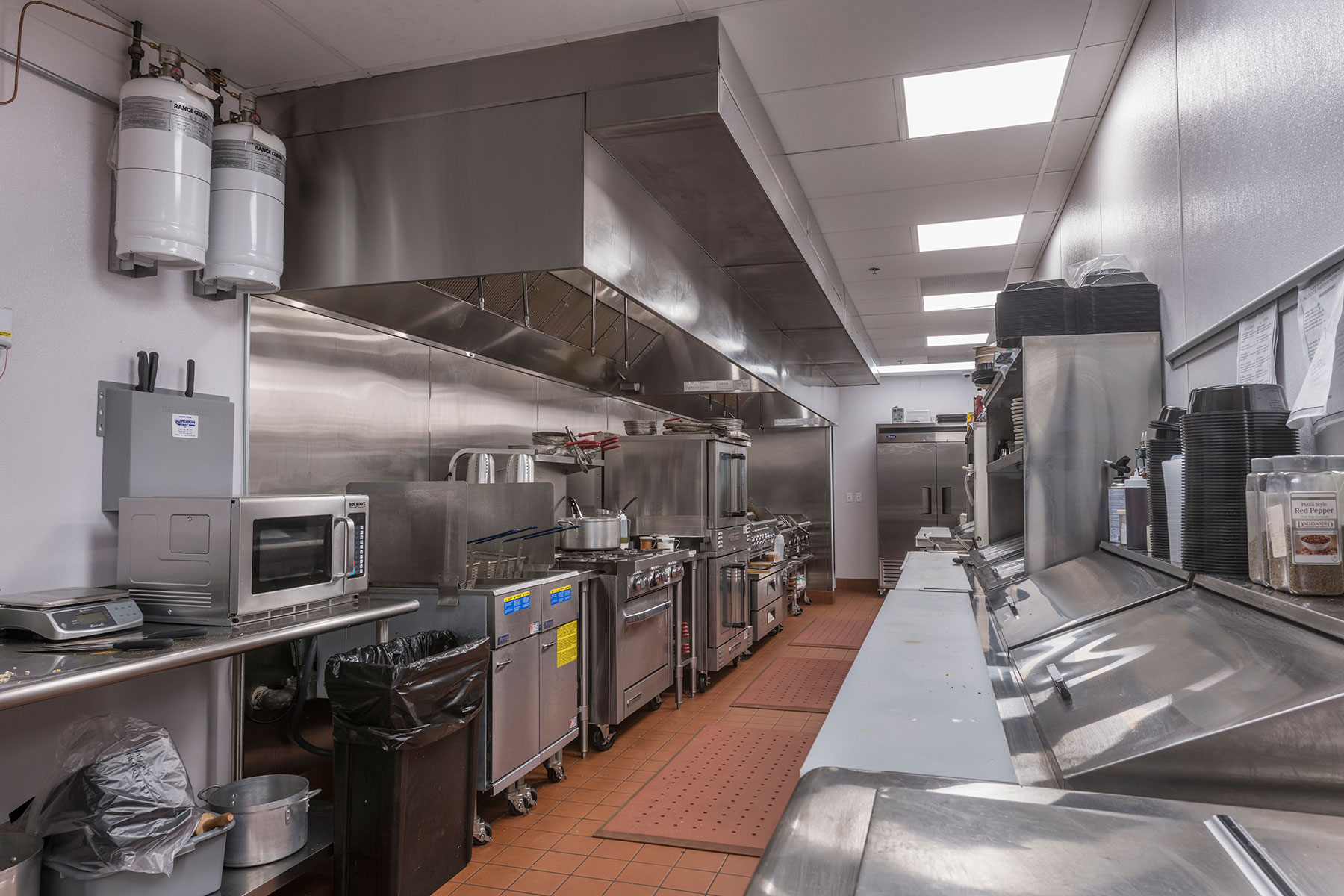 Commercial cooking hood with equipment - Four Seasons Steak & Grill Restaurant, Addison Custom Home. America's Custom Home Builders: New Construction, Remodeling, Restoration Services. Residential and Commercial.
